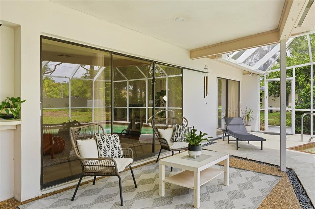 3927 Country View Lane Sarasota, FL 34233 - Photo 43 of 48 a view of a chairs and table in a patio