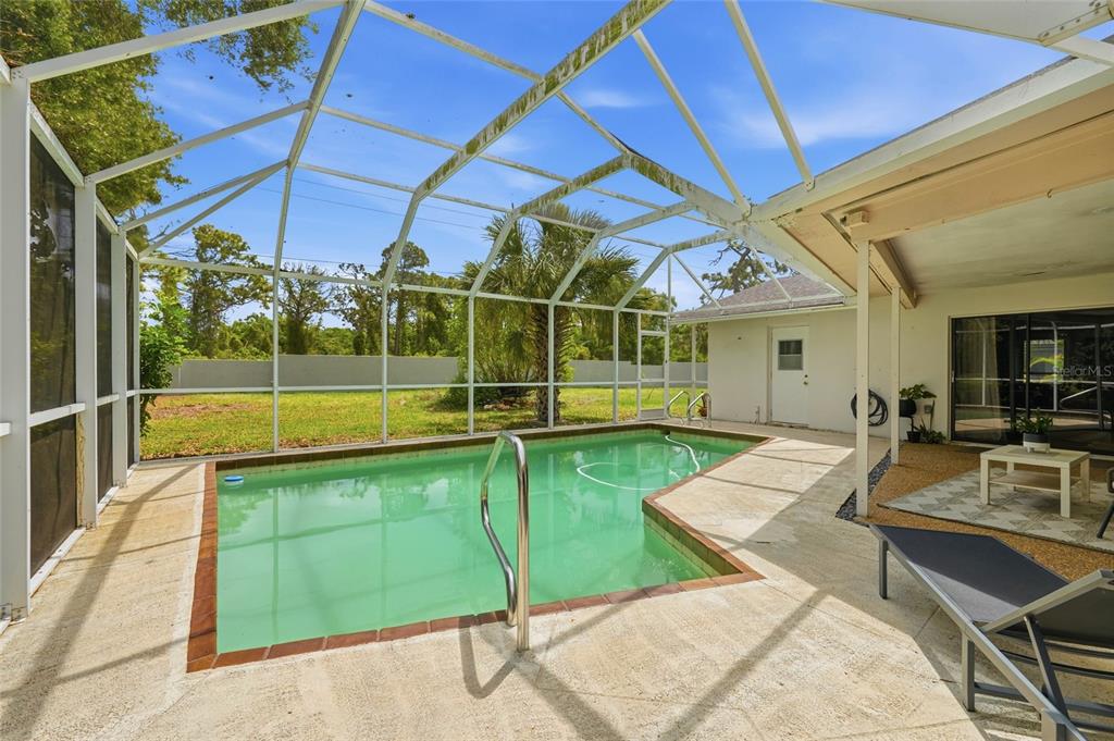 3927 Country View Lane Sarasota, FL 34233 - Photo 44 of 48 a view of a backyard with a patio and swimming pool