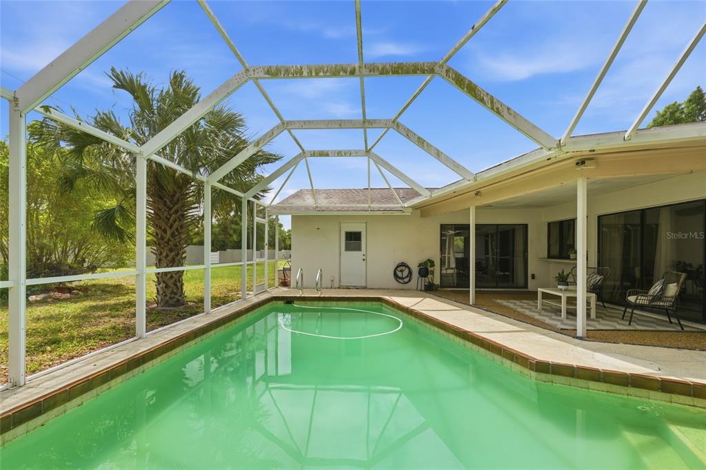 3927 Country View Lane Sarasota, FL 34233 - Photo 45 of 48 a view of a backyard with a patio and a garden
