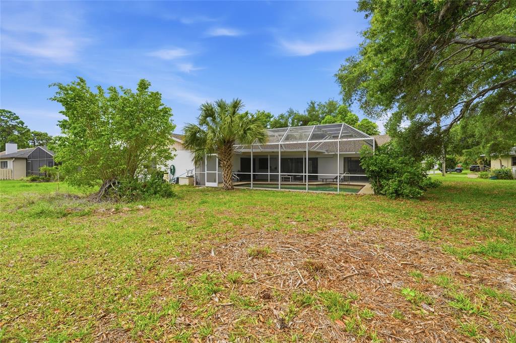 3927 Country View Lane Sarasota, FL 34233 - Photo 47 of 48 a view of a house with a yard