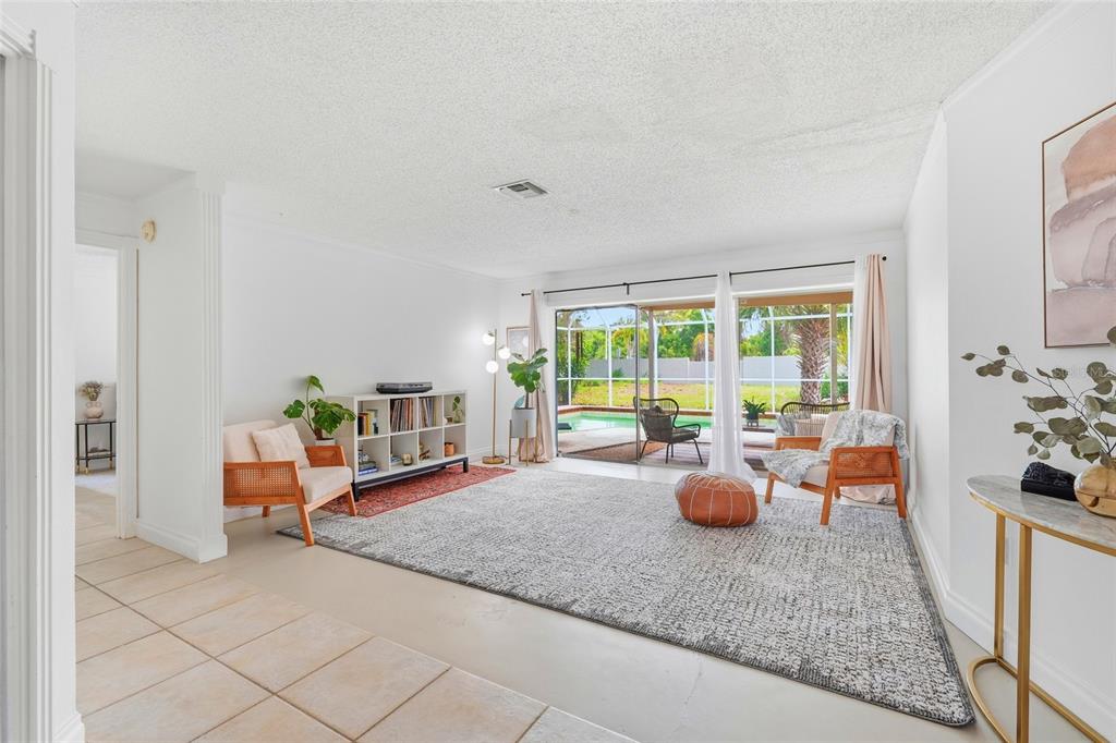 3927 Country View Lane Sarasota, FL 34233 - Photo 5 of 48 a living room with furniture and large windows