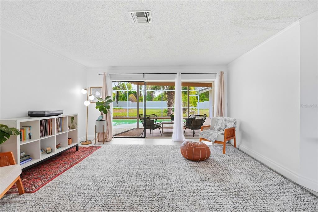 3927 Country View Lane Sarasota, FL 34233 - Photo 6 of 48 a living room with furniture and a flat screen tv