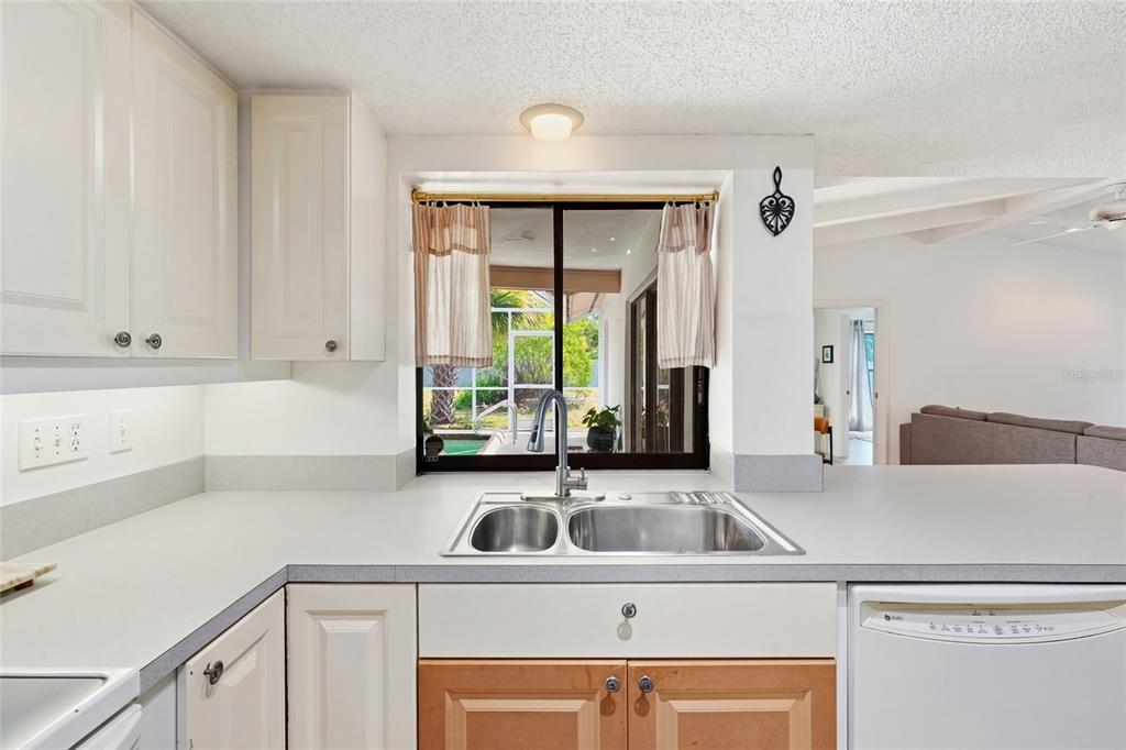 3927 Country View Lane Sarasota, FL 34233 - Photo 10 of 48 a view of a kitchen sink a faucet and a refrigerator