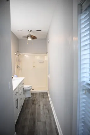 a bathroom with a sink a toilet and a shower
