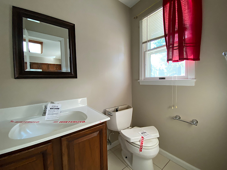 1628 North 2510th Road Ottawa, IL 61350 - Photo 9 of 24 a bathroom with a toilet sink vanity and mirror