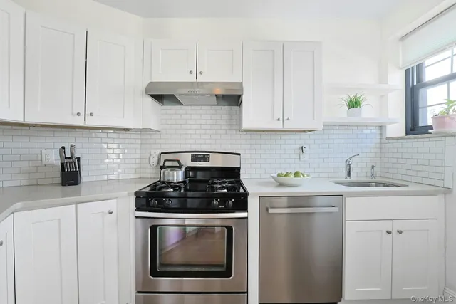 a kitchen with cabinets appliances and a sink