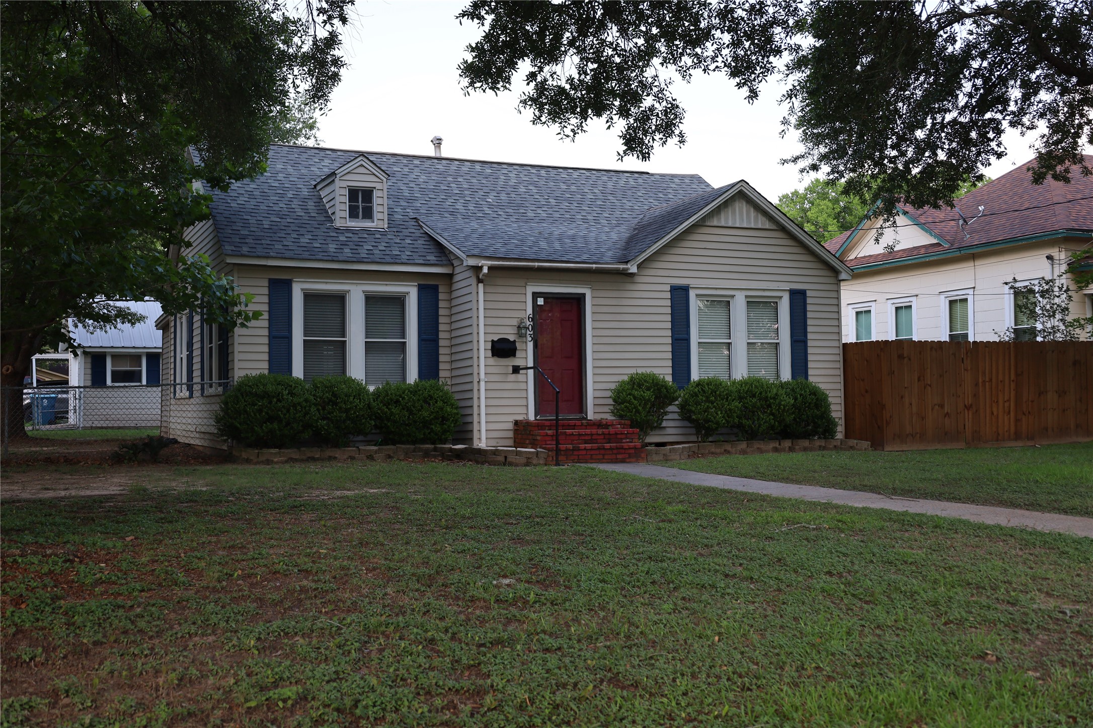 a front view of a house with a garden