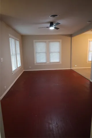 a view of a chandelier fan and wooden floor
