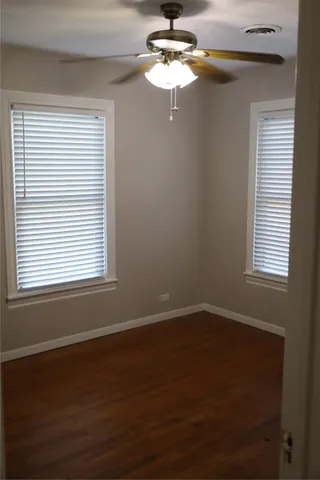 a bathroom with a granite countertop sink toilet and a mirror