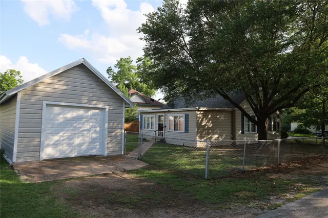 a view of a house with a yard and sitting area