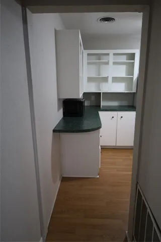 a view of storage and utility room with wooden floor
