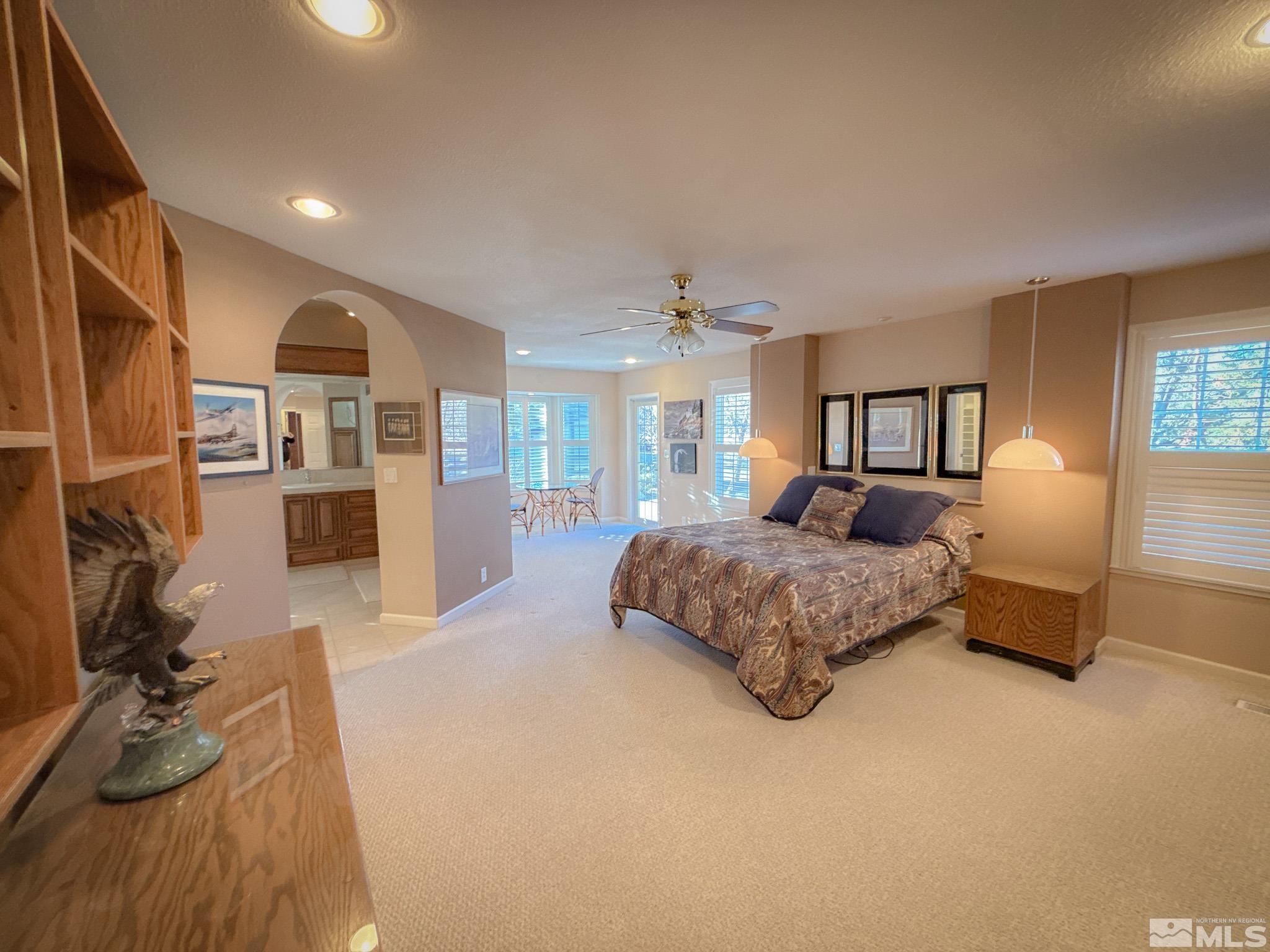 3775 Clover Way Reno, NV 89509 - Photo 13 of 40 a spacious bedroom with a large bed and a chandelier