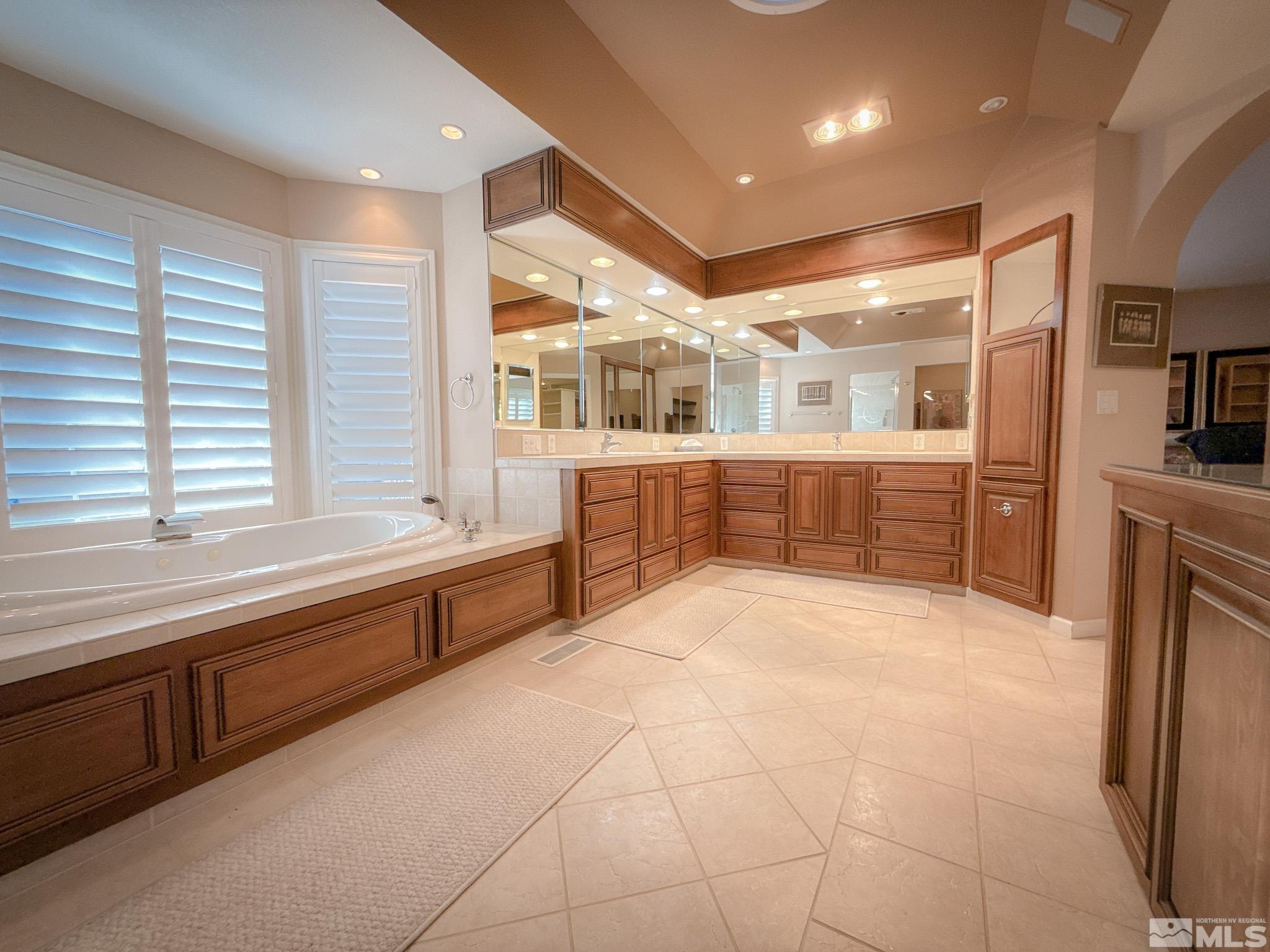 3775 Clover Way Reno, NV 89509 - Photo 19 of 40 a large white kitchen with kitchen island a large window a sink and stainless steel appliances