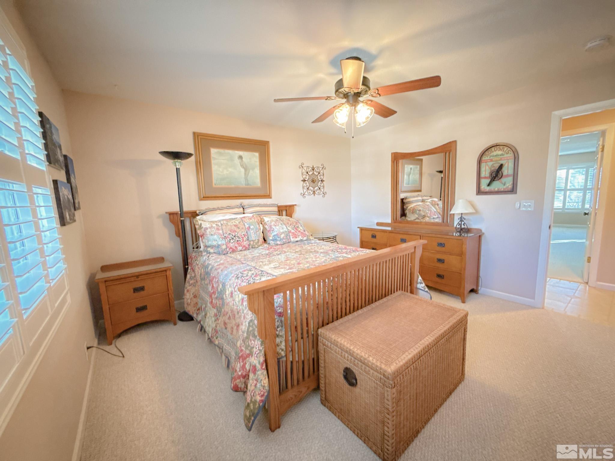 3775 Clover Way Reno, NV 89509 - Photo 23 of 40 a bedroom with a bed and a chandelier