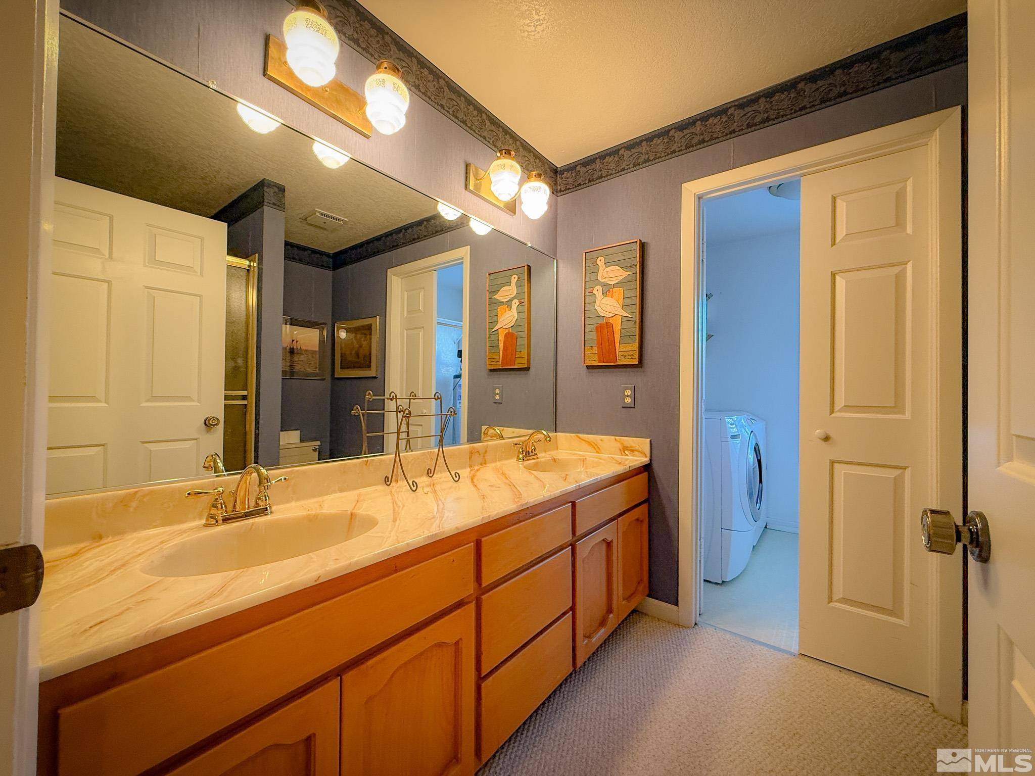 3775 Clover Way Reno, NV 89509 - Photo 26 of 40 a bathroom with a granite countertop sink and a mirror