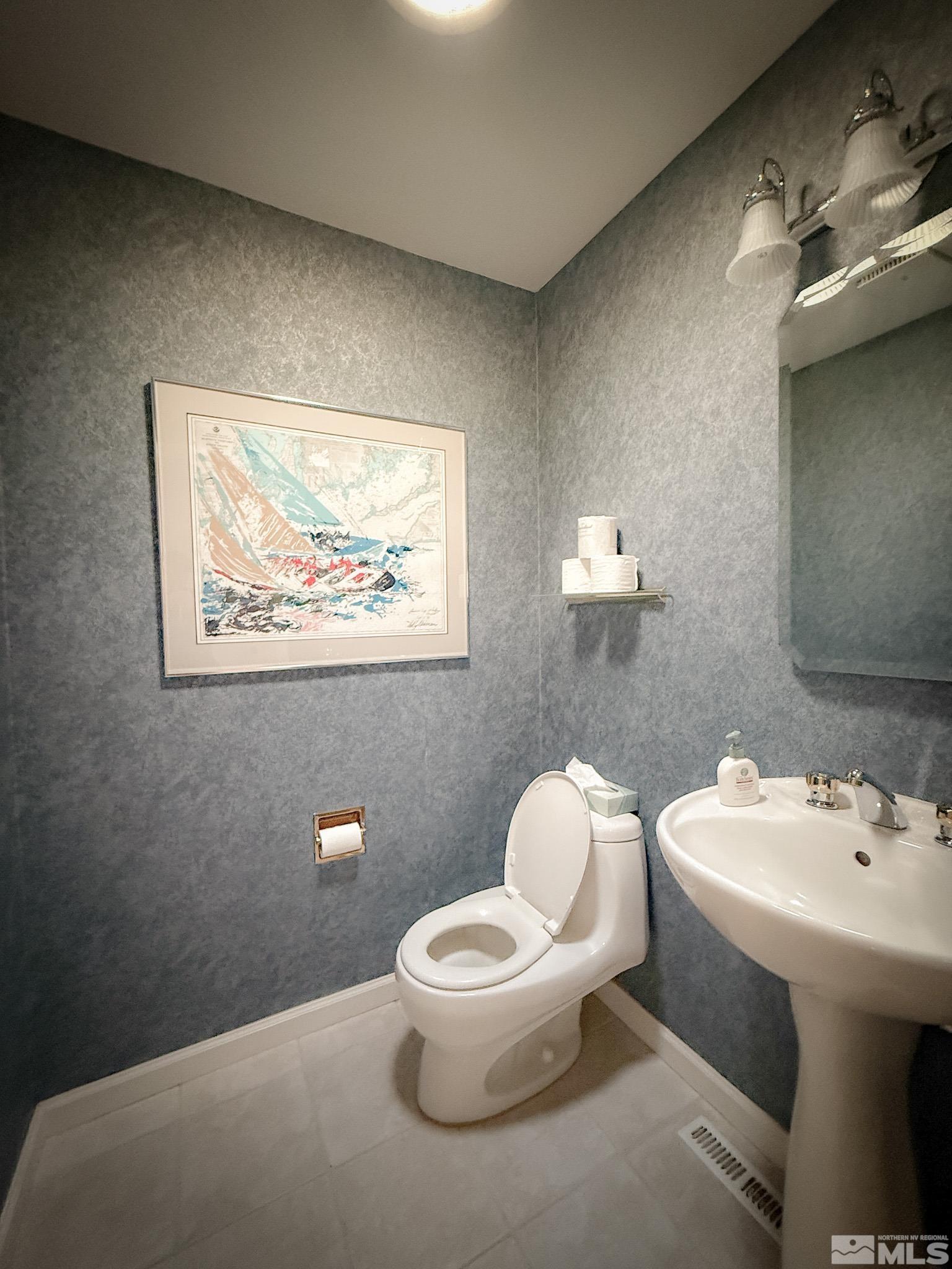 3775 Clover Way Reno, NV 89509 - Photo 28 of 40 a white toilet sitting next to a bathroom sink