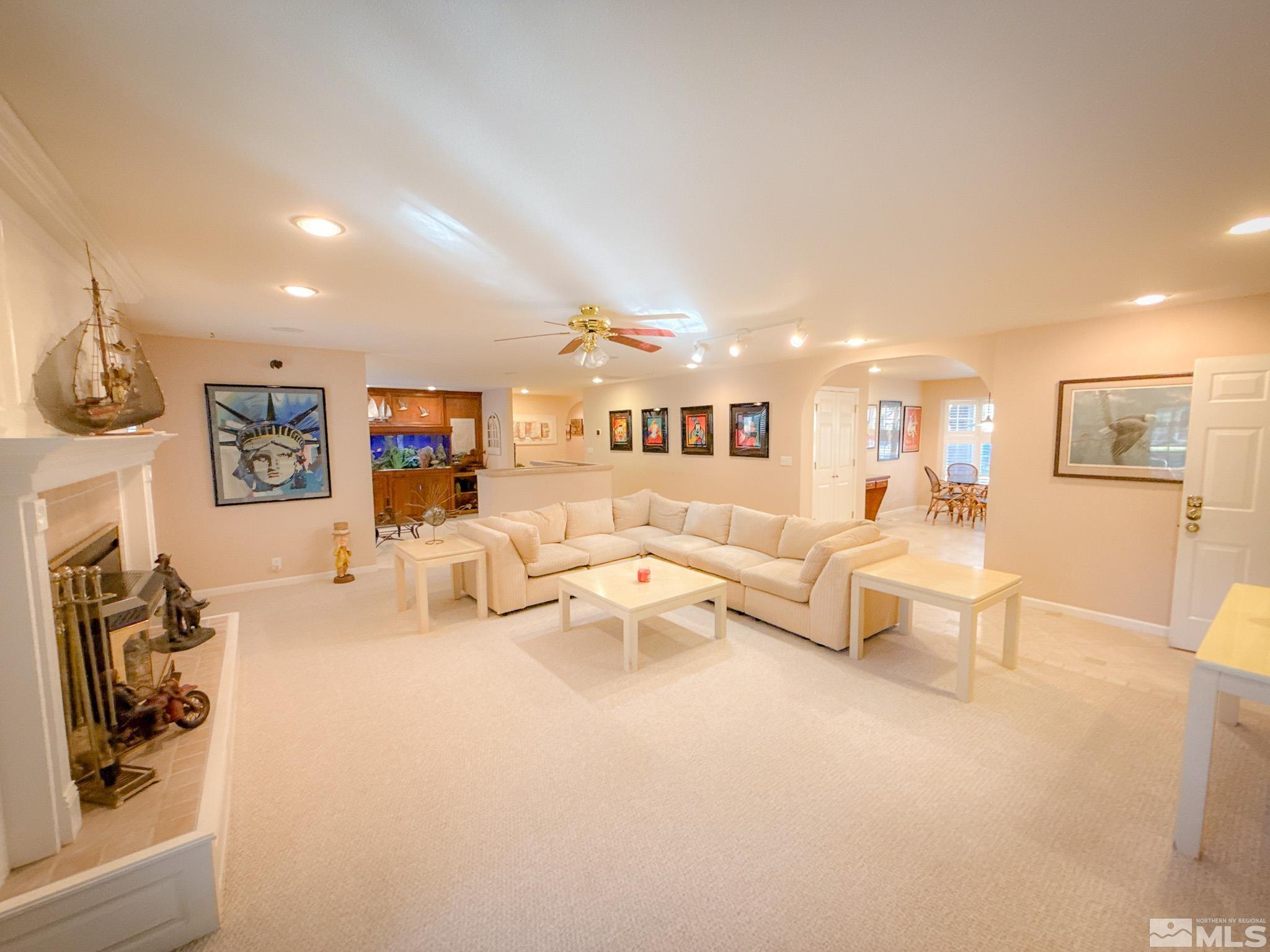 3775 Clover Way Reno, NV 89509 - Photo 5 of 40 a living room with furniture a couch and a fireplace