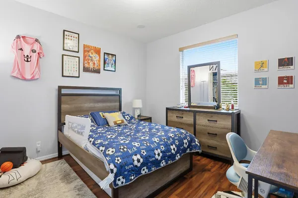 a bedroom with a bed and a dresser in it