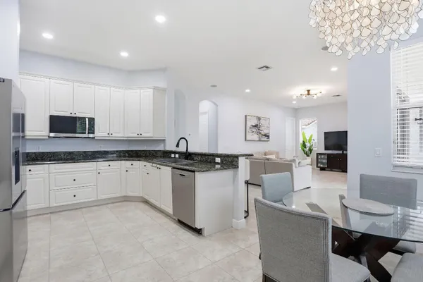 a large white kitchen with cabinets