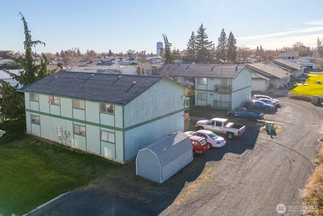a backyard of a house with table and chairs