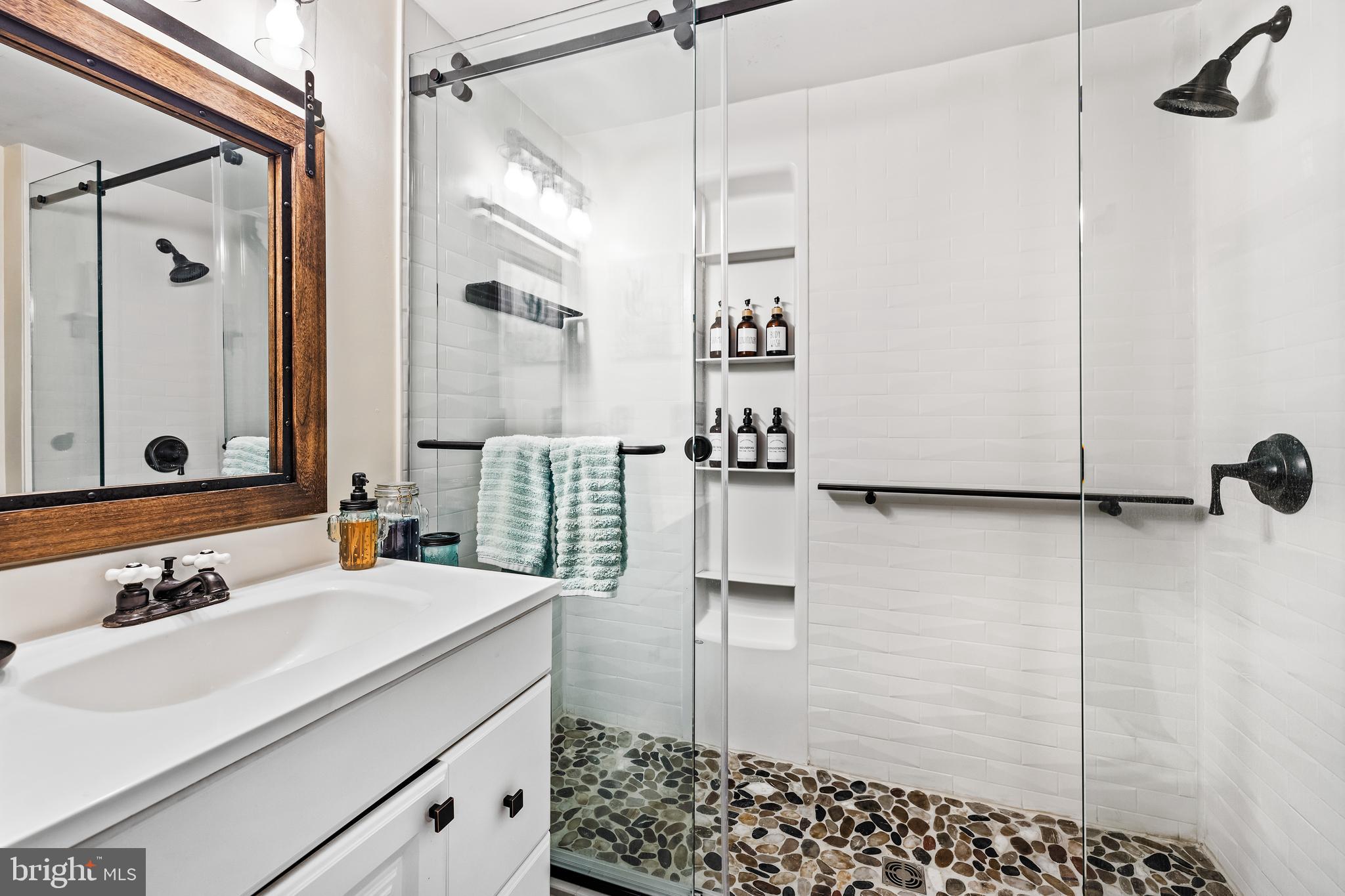 1030 South Main Street Hampstead, MD 21074 - Photo 13 of 20 a bathroom with a sink and a mirror