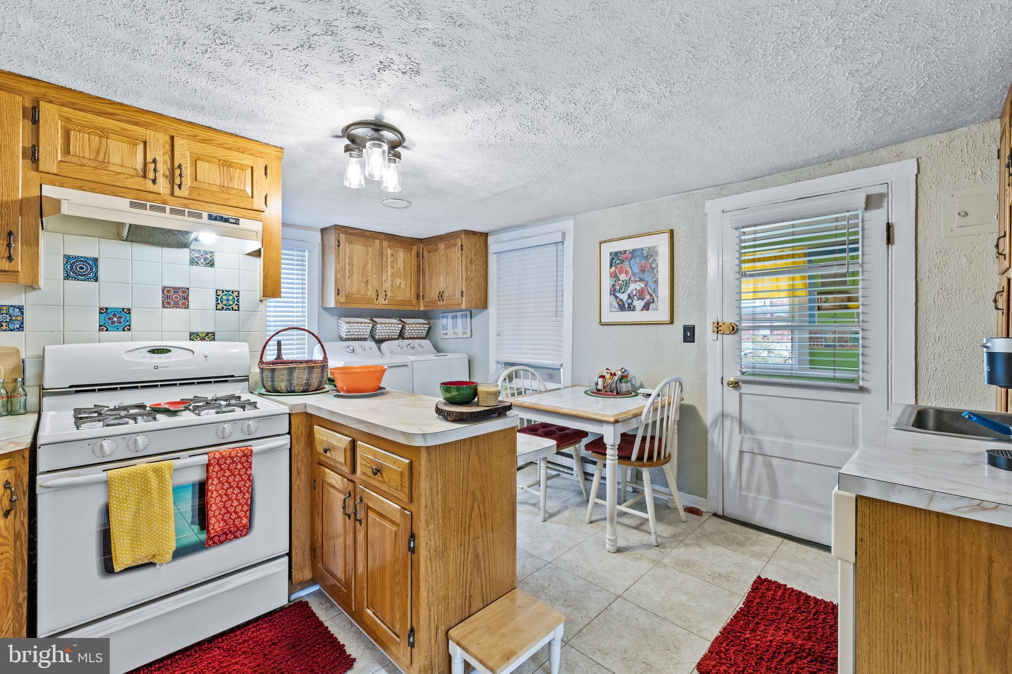 1030 South Main Street Hampstead, MD 21074 - Photo 6 of 20 a view of a kitchen area with furniture and window
