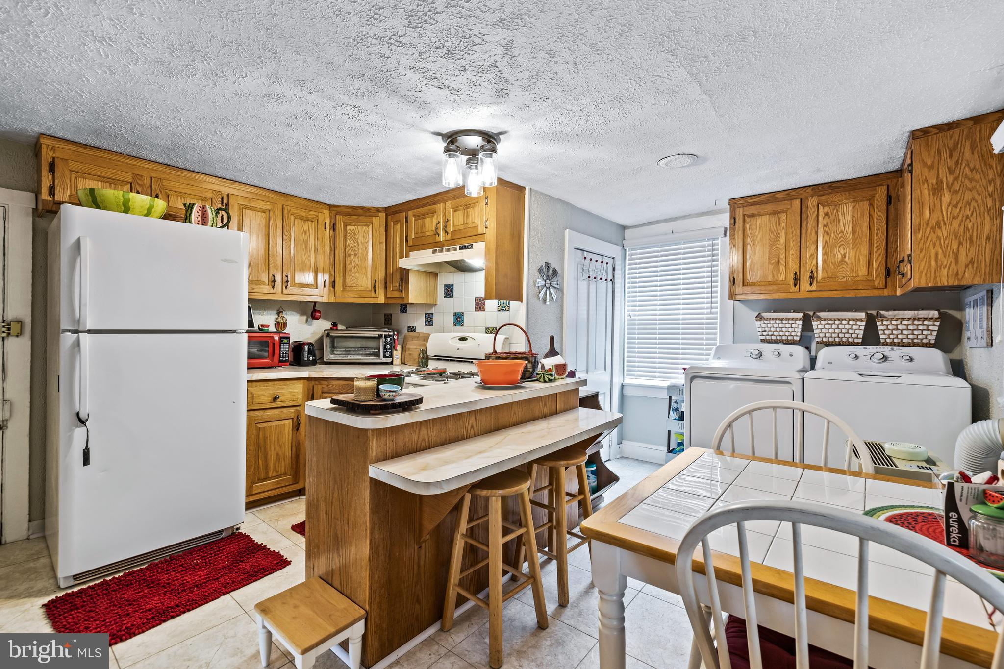 1030 South Main Street Hampstead, MD 21074 - Photo 10 of 20 a kitchen with stainless steel appliances a stove a sink cabinets and a refrigerator