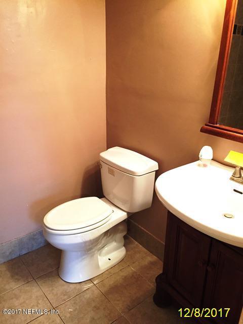 7345 Ridgeway Road North Jacksonville, FL 32244 - Photo 12 of 26 a white toilet sitting next to a bathroom sink