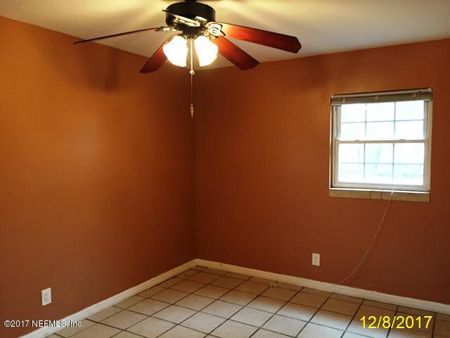 7345 Ridgeway Road North Jacksonville, FL 32244 - Photo 19 of 26 an empty room with a ceiling fan and a window