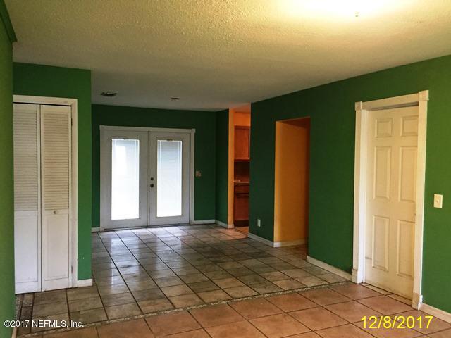 7345 Ridgeway Road North Jacksonville, FL 32244 - Photo 3 of 26 a view of a hallway with wooden shelves