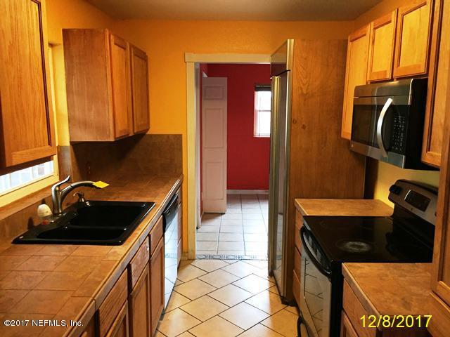 7345 Ridgeway Road North Jacksonville, FL 32244 - Photo 9 of 26 a kitchen with a refrigerator and a stove