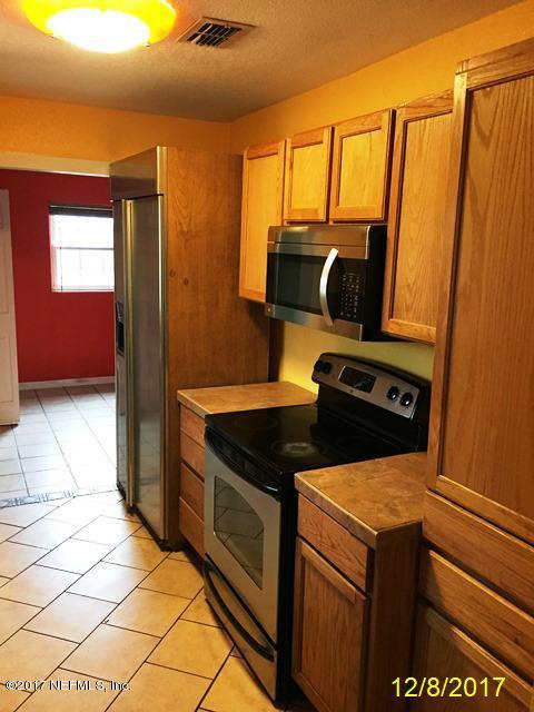 7345 Ridgeway Road North Jacksonville, FL 32244 - Photo 10 of 26 a kitchen with a stove and a refrigerator