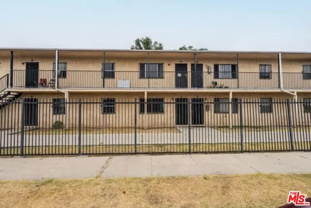 a view of a house with iron fence