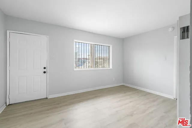 a kitchen with a refrigerator and cabinets