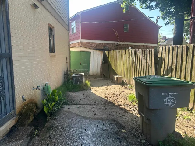a view of a pathway of a house with a yard
