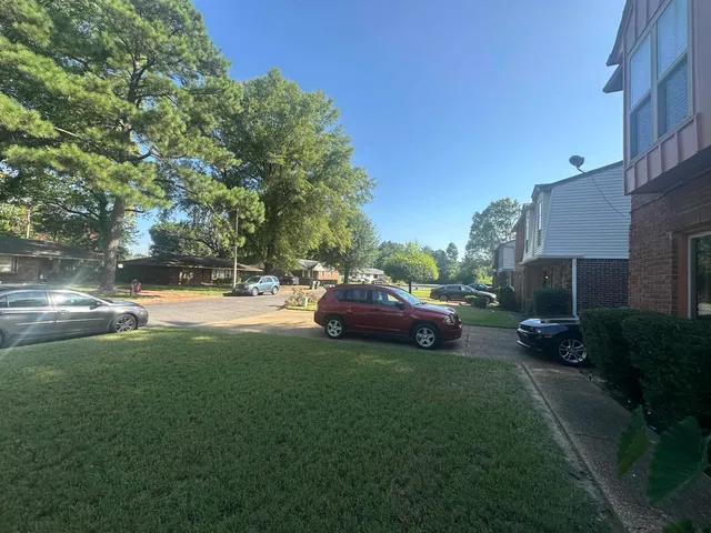 a couple of cars parked in front of a house