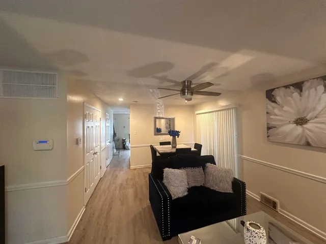 a living room with furniture and a wooden floor