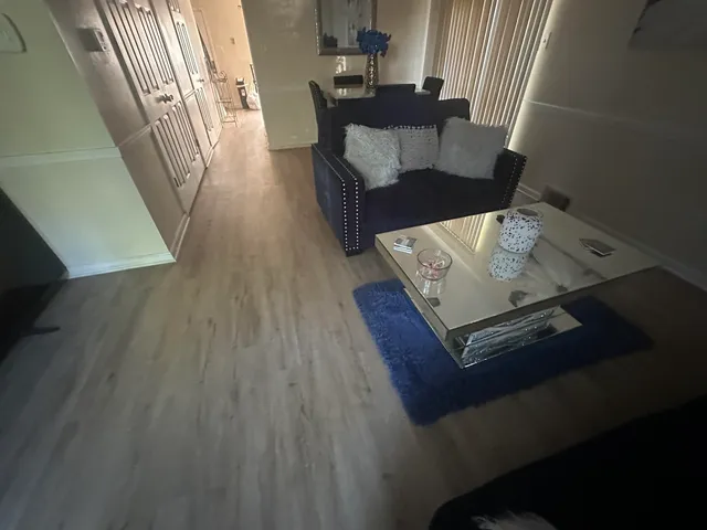 a view of a living room and wooden floor