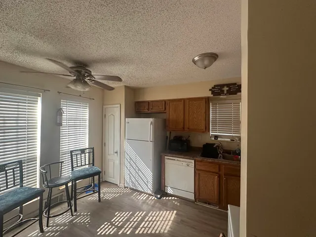 a kitchen with stainless steel appliances a refrigerator and a stove top oven