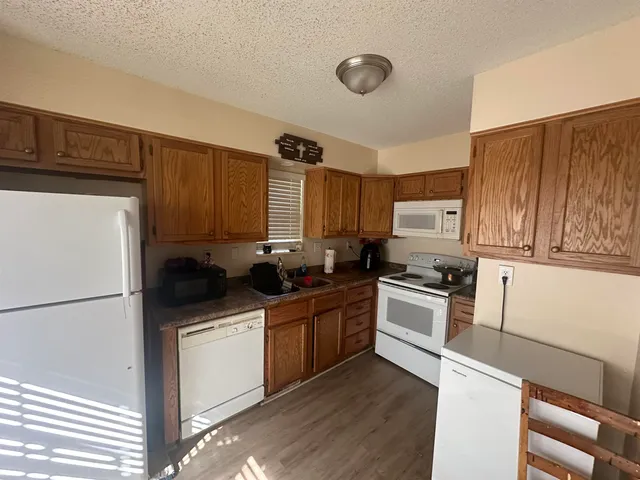 a kitchen with a sink stove and refrigerator