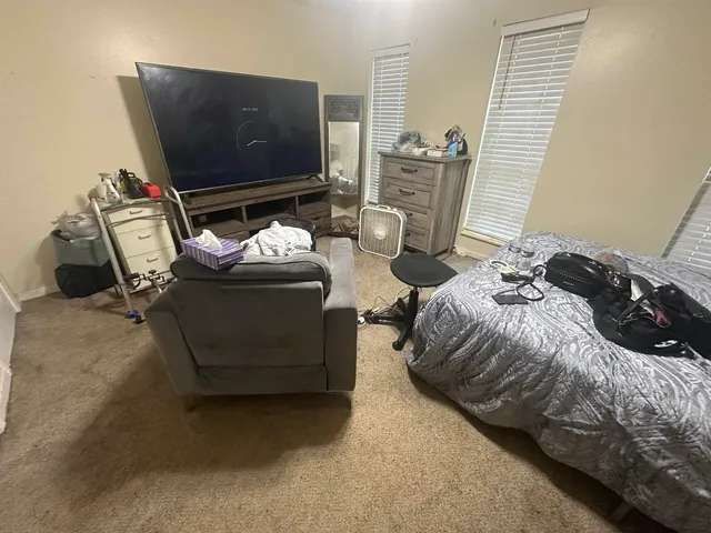 a bedroom with bed and window