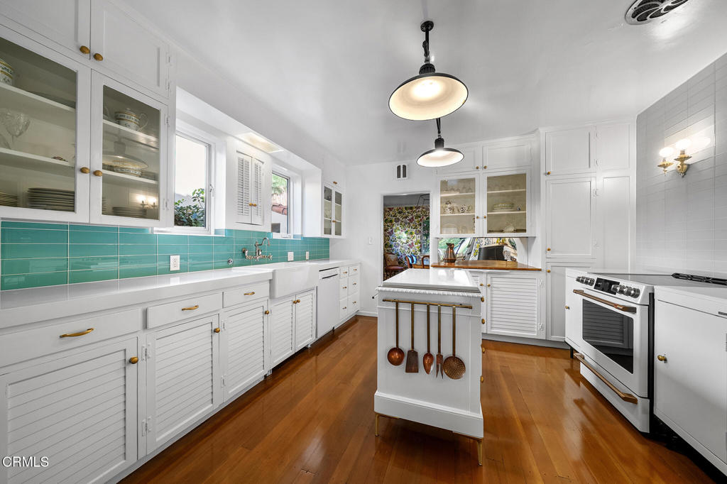1765 Westhaven Road San Marino, CA 91108 - Photo 17 of 71 a kitchen with stainless steel appliances granite countertop a stove a sink and white cabinets with wooden floor