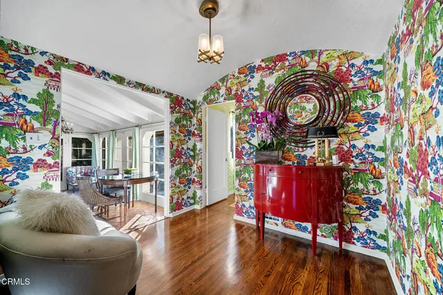 a view of a patio with a table chairs and a floor to ceiling window
