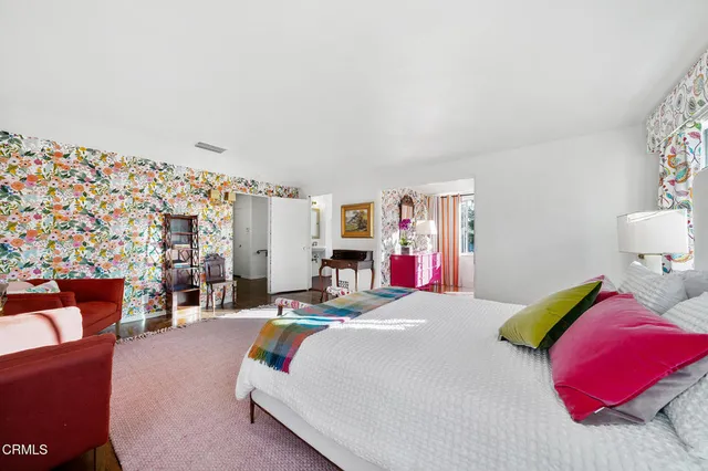 a view of a hallway with wooden floor closet and living room