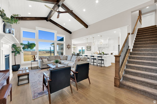 352 East Boulderville Road Oakley, UT 84055 - Photo 11 of 62 Living area featuring ceiling fan, a fireplace, light wood-style flooring, and hanging lights