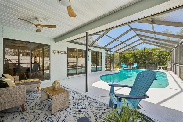 a swimming pool with outdoor seating and yard
