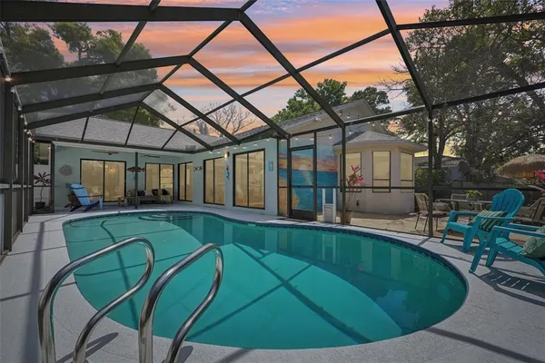 a backyard of a house with table and chairs