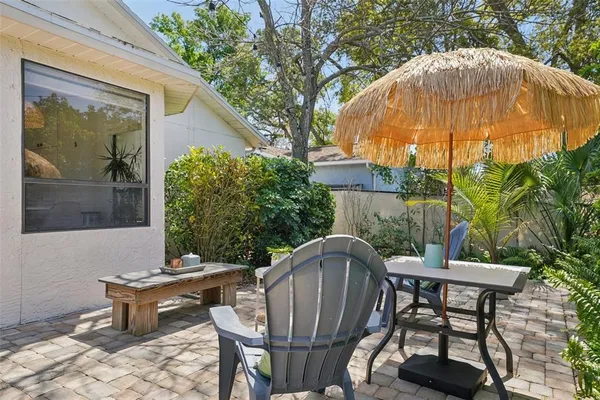 an aerial view of residential houses with outdoor space and trees