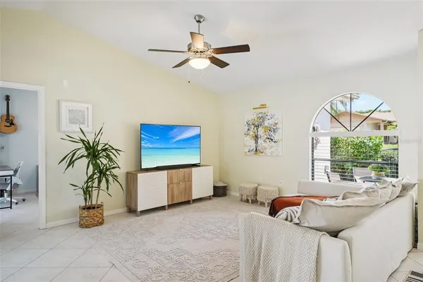 a bedroom with a bed a couch and a potted plant