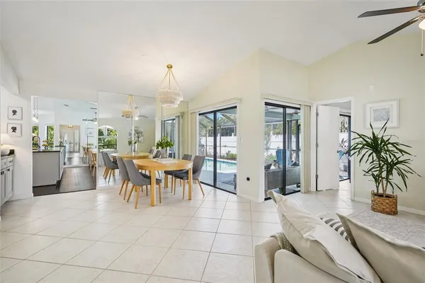 a kitchen with stainless steel appliances kitchen island granite countertop a table chairs and white cabinets